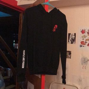 A black girl’s hoodie with a red rose on the chest